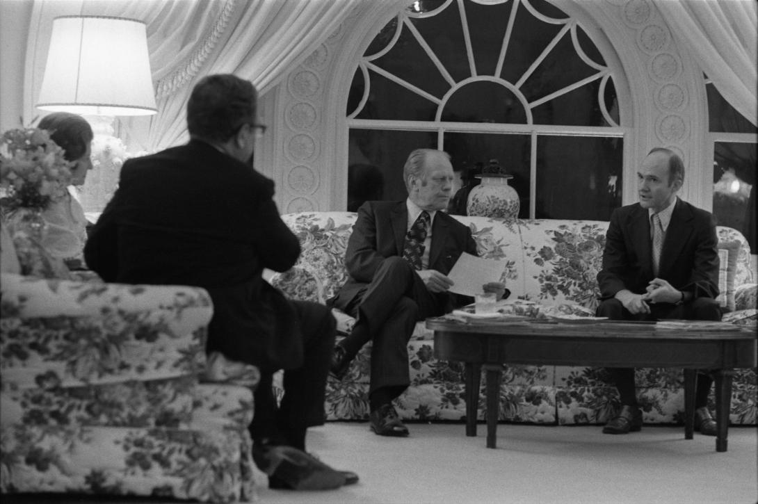 A4233-07A. President Ford discusses the evacuation of Saigon with Secretary of State Henry Kissinger and Deputy Assistant for National Security Affairs Brent Scowcroft during a late night meeting in the White House residence. April 28, 1975.