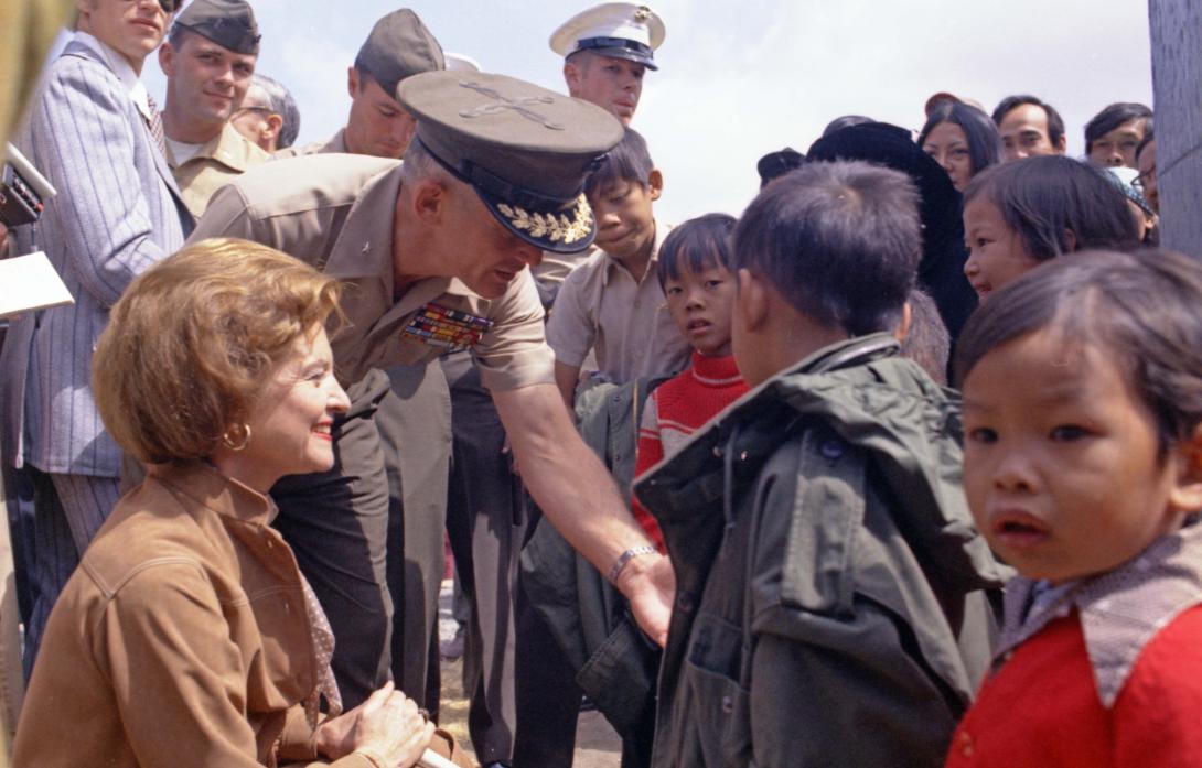 A4669-13. First Lady Betty Ford greets newly-arrived Vietnamese children at the Camp Pendleton Refugee Camp in California.  May 21, 1975. 