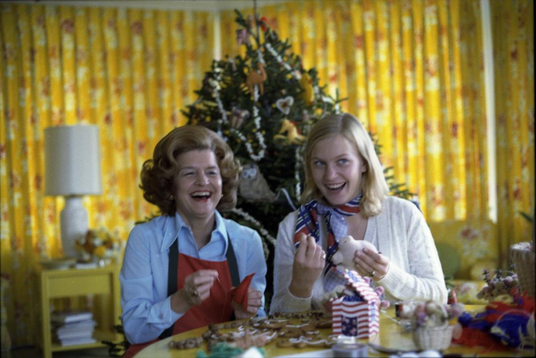 A7235-08. Having selected “handmade and folksy” as the theme for Christmas at the White House, First Lady Betty Ford makes homemade ornaments with daughter Susan for the tree in the third floor Solarium during a photo-op for Parade Magazine.  November 10, 1975. 