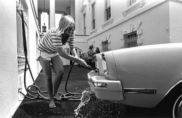 B0159-15. Susan Ford washes her car outside the White House. June 9, 1976.