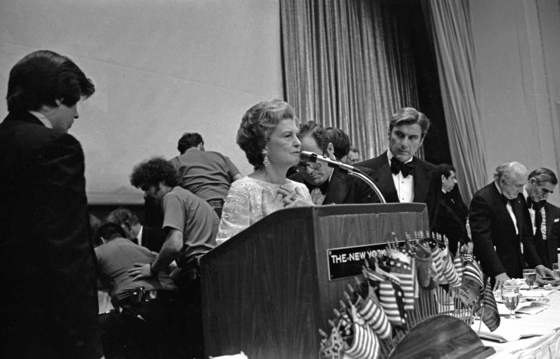 B0342-06A. First Lady Betty Ford offers a prayer for Jewish National Fund president Rabbi Maurice Sage who collapsed onstage from a heart attack just before presenting her with a Bible at the Fund’s gala dinner to inaugurate the American Bicentennial National Park in Israel.   June 22, 1976.