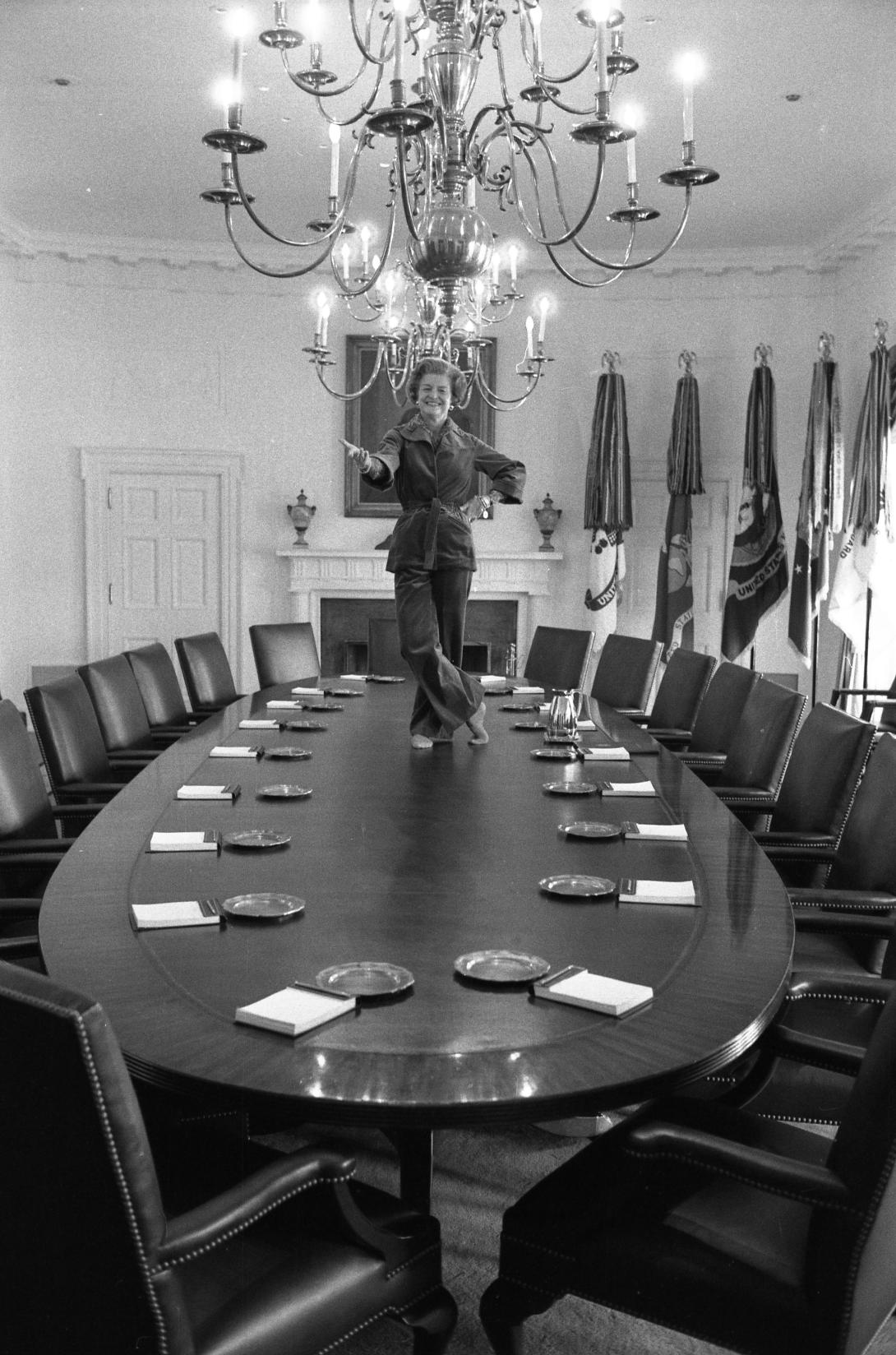 B2843-09A. First Lady Betty Ford dances on the Cabinet Room table on the day before departing the White House upon the inauguration of President Jimmy Carter.   January 19, 1977. 