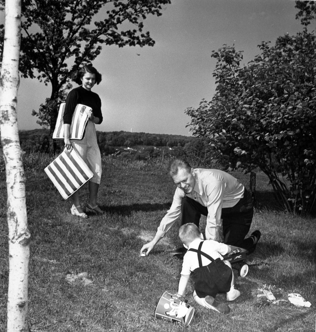 H0009-2. Betty joins husband Jerry (then a young Congresssman) and son Michael for some play in the yard outside their apartment at 1521 Mount Eagle Place, Alexandria, Virginia. 1952.