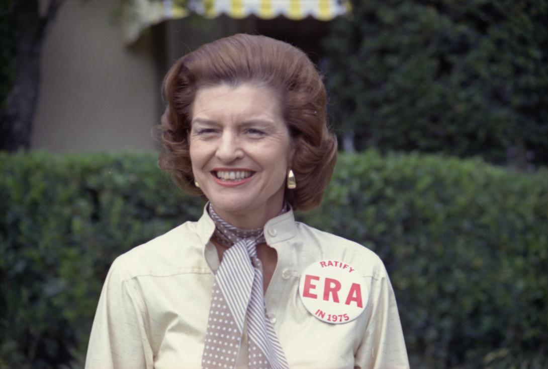 A3455-21A. First Lady Betty Ford sports a button expressing her support for ratification of the Equal Rights Amendment while taking some personal time as President Ford plays in the Jackie Gleason Inverrary Classic Celebrities Golf Tournament, Hollywood, Florida.   February 26, 1975. 