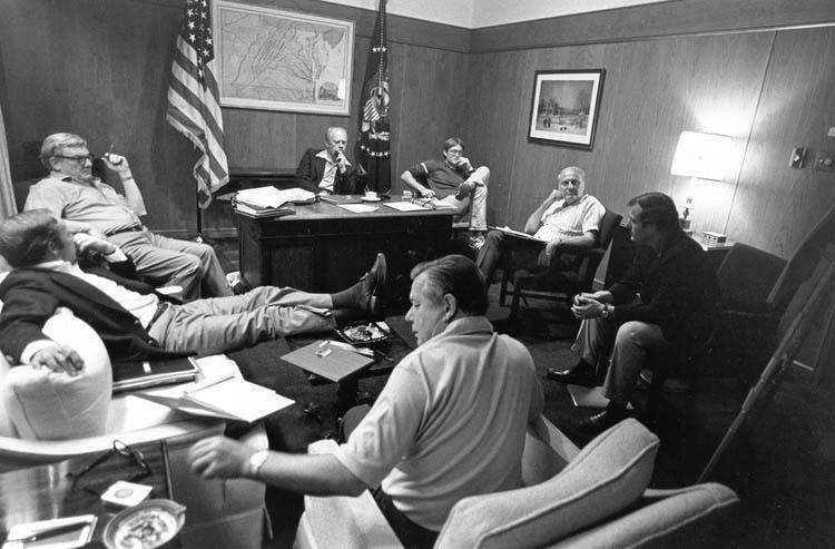 B0984-30. President Ford discusses campaign strategy with some of his staff at Camp David. August 6, 1976. (clockwise from the President - Jack Ford, John Marsh, Robert M. Teeter (Vice President - Market Opinion Research Corp.), Stuart Spencer (President Ford Committee Deputy Chairman for Political Organization), Dick Cheney, and Robert Hartmann.)