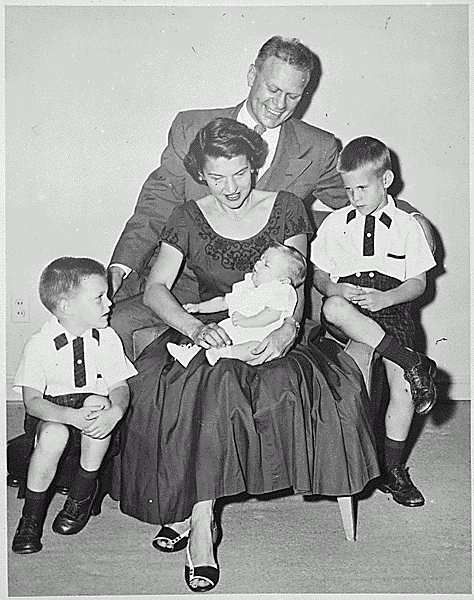 H0006-3. Mrs. Ford holds Steven Ford as Gerald R. Ford, Jr., Jack Ford, and Michael Ford look on. June 1956.