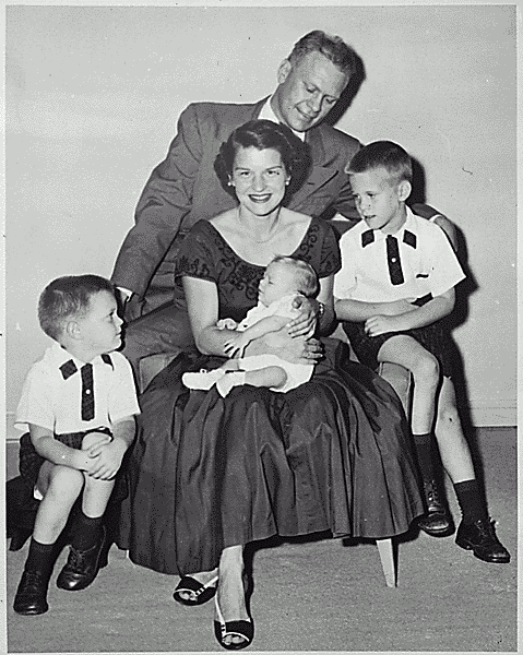 H0007-4. Mrs. Ford holds Steven Ford as Gerald R. Ford, Jr., Jack Ford, and Michael Ford look on. June 1956.