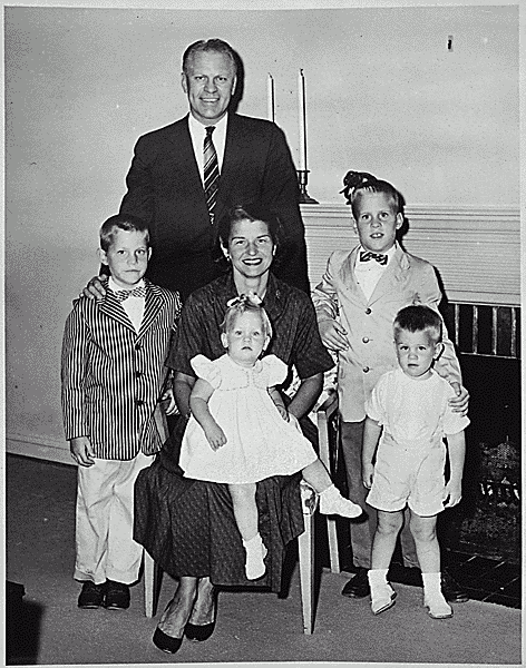 H0008-1. The Ford family poses in front of the fireplace at 514 Crown View Drive, Alexandria, VA. 1959.