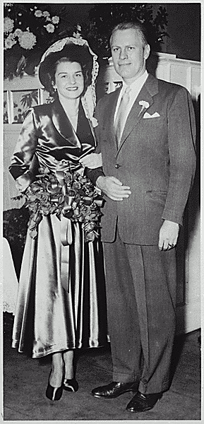 H0013-4. Gerald R. Ford, Jr., and Betty Ford pose in front of the ambo in Grace Episcopal Church in Grand Rapids, MI, following their marriage. October 15, 1948.