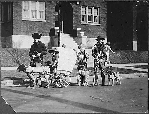 H0023-4. Gerald R. Ford, Jr., Carl Engel, Tom Ford, and an unidentified boy pose with their pioneer wagon after winning first prize in the Boys Day Parade. 1923.