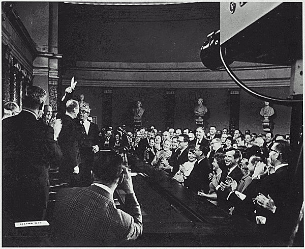 H0049-2. As House Republicans show their approval, Senate Minority Leader Everett M. Dirksen raises the hand of Gerald R. Ford, newly elected House Minority Leader. January 1965.